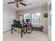 Well-lit home office with dual monitors, neutral walls, and carpet at 3511 Dominion Green Dr, Charlotte, NC 28269