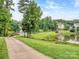 Picturesque pond with a fountain, walking path and bridge at 3511 Dominion Green Dr, Charlotte, NC 28269