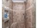 Walk-in shower featuring tile surround, built-in seat, and shower caddy at 3511 Dominion Green Dr, Charlotte, NC 28269