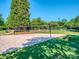Well-maintained sand volleyball court surrounded by lush greenery and park benches at 3511 Dominion Green Dr, Charlotte, NC 28269