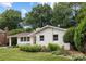 Beautiful one-story home featuring manicured landscaping, a covered entrance and blue door at 4017 Sulkirk Rd, Charlotte, NC 28210