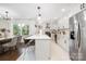 Eat-in kitchen featuring stainless appliances, white cabinets, a large island, and marble floors at 4017 Sulkirk Rd, Charlotte, NC 28210