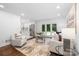Inviting living room featuring plush seating, French doors and hardwood floors at 4017 Sulkirk Rd, Charlotte, NC 28210