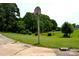 Large backyard featuring a basketball hoop, open green space, and mature shade trees at 405 Wesley Heights Dr, Albemarle, NC 28001