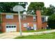 Spacious brick home with a two-car garage, a basketball hoop, and a large backyard at 405 Wesley Heights Dr, Albemarle, NC 28001