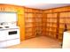 Retro basement featuring wood paneling, built-in shelving, and vintage appliances at 405 Wesley Heights Dr, Albemarle, NC 28001