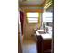 Bathroom with a single sink vanity, tiled floor, and natural light at 405 Wesley Heights Dr, Albemarle, NC 28001