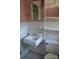 Bathroom showing a square sink with chrome faucets, matching mirror, white tiled walls, and toilet at 405 Wesley Heights Dr, Albemarle, NC 28001