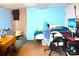 This bedroom has blue walls with a sofa, bed, desk and a ceiling fan at 405 Wesley Heights Dr, Albemarle, NC 28001