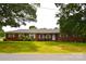 All brick house featuring a well-manicured lawn and mature trees in a quiet neighborhood at 405 Wesley Heights Dr, Albemarle, NC 28001