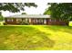 Traditional brick home with a spacious front yard and classic white-framed windows at 405 Wesley Heights Dr, Albemarle, NC 28001