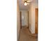 Hallway featuring neutral color palette, neutral carpeting, and paneled doors at 405 Wesley Heights Dr, Albemarle, NC 28001