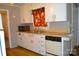 Cozy eat-in kitchen featuring retro appliances, hardwood flooring, and neutral walls at 405 Wesley Heights Dr, Albemarle, NC 28001