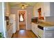 Cozy eat-in kitchen featuring retro appliances, hardwood flooring, and floral curtains at 405 Wesley Heights Dr, Albemarle, NC 28001