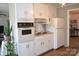 Cozy eat-in kitchen featuring retro appliances, hardwood flooring, and neutral walls at 405 Wesley Heights Dr, Albemarle, NC 28001
