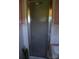Bathroom featuring a shower with a framed door, next to a white tiled wall and corner of a sink at 405 Wesley Heights Dr, Albemarle, NC 28001