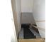 A view of the stairwell leading downstairs featuring gray stairs and white walls at 405 Wesley Heights Dr, Albemarle, NC 28001