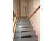 Stairwell with gray stairs, a white railing, and textured walls, leading to another level at 405 Wesley Heights Dr, Albemarle, NC 28001