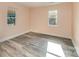 Bedroom with wood-look floors, and natural light from two new windows at 408 Orange St, Shelby, NC 28150