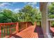 A spacious wooden deck with railing providing a scenic view of the surrounding green trees at 408 Orange St, Shelby, NC 28150