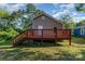 Back exterior view of a two story home featuring a wooden deck, vinyl siding, and a well maintained lawn at 408 Orange St, Shelby, NC 28150