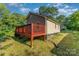 Back exterior view of a two story home featuring a wooden deck, vinyl siding, and a well maintained lawn at 408 Orange St, Shelby, NC 28150