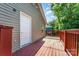 View of home exterior with a private wooden deck, vinyl siding, and a white exterior door at 408 Orange St, Shelby, NC 28150