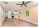 Open concept kitchen with white cabinets, modern appliances, and wood flooring at 408 Orange St, Shelby, NC 28150