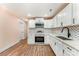 Updated kitchen featuring stainless steel appliances, white cabinets, and ample counter space at 408 Orange St, Shelby, NC 28150