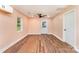 Open concept living room featuring wood floors, a ceiling fan and natural light at 408 Orange St, Shelby, NC 28150