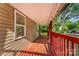 Covered porch featuring a red deck and wood-paneled siding at 408 Orange St, Shelby, NC 28150