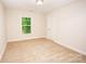Bright bedroom featuring neutral walls, plush carpeting, and a window offering a glimpse of greenery at 506 Broadway Ct, Statesville, NC 28677