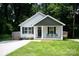 Charming home with a well-maintained lawn, a covered front porch, and a modern exterior at 506 Broadway Ct, Statesville, NC 28677