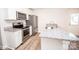 Well-equipped kitchen featuring granite counters, stainless appliances, and stylish white cabinetry at 506 Broadway Ct, Statesville, NC 28677