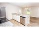 Beautiful eat in kitchen with granite countertops, stainless dishwasher, and hardwood floors at 506 Broadway Ct, Statesville, NC 28677