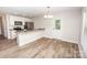 Bright kitchen with white cabinets, stainless steel appliances, granite countertops, and hardwood floors at 506 Broadway Ct, Statesville, NC 28677