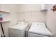 Functional laundry room featuring a washer, a dryer, and shelving for storage at 506 Broadway Ct, Statesville, NC 28677