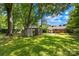 Lush backyard with mature trees, a gazebo, and an charming view of home at 506 Gold St, Shelby, NC 28150