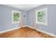 Cozy bedroom with hardwood floors, neutral paint, and two windows offering natural light at 506 Gold St, Shelby, NC 28150