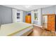 Charming bedroom featuring hardwood floors, two windows, and classic furnishings at 506 Gold St, Shelby, NC 28150