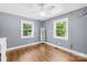 Bright bedroom with hardwood floors, two windows and modern ceiling fan at 506 Gold St, Shelby, NC 28150