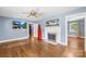 Cozy living room featuring hardwood floors, a fireplace, and a ceiling fan, creating a welcoming space at 506 Gold St, Shelby, NC 28150