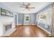 Living room featuring hardwood floors, a fireplace, and bright windows, perfect for entertaining and relaxation at 506 Gold St, Shelby, NC 28150