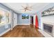 A cozy living room with hardwood floors, a fireplace, and a ceiling fan provides comfortable living space at 506 Gold St, Shelby, NC 28150