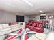 Finished basement with white and red seating, bar area, and custom rug at 5105 Hampton Meadows Rd, Monroe, NC 28110