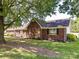 Picture of a red brick home with a large tree in the foreground on a large lot at 5105 Hampton Meadows Rd, Monroe, NC 28110