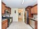 Bright kitchen with stainless steel appliances, wooden cabinets and tiled floors at 5105 Hampton Meadows Rd, Monroe, NC 28110
