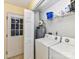 Bright laundry room with washer, dryer, shelving, and access to the exterior at 5105 Hampton Meadows Rd, Monroe, NC 28110