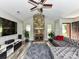Living room boasts stone fireplace, vaulted ceilings, wood floors, and grey sofa at 5105 Hampton Meadows Rd, Monroe, NC 28110