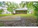 A backyard featuring a wooden deck and a concrete pad in a grassy area at 5424 Amado St, Charlotte, NC 28215